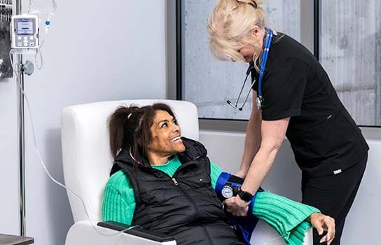 Nurse monitoring a transfusion patient
