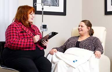 Nurse helping an infusion patient