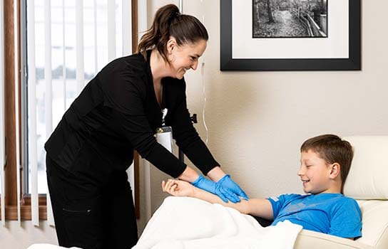 Child receiving medical transfusion